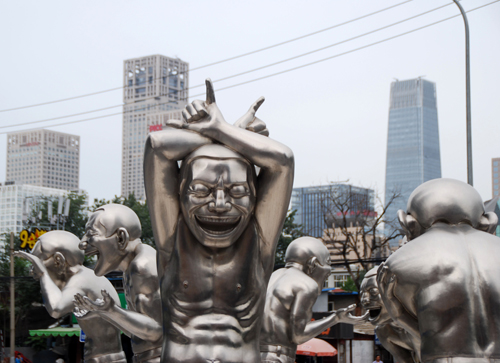 Skulptur utanför Today Art museum av Yue Minjun.